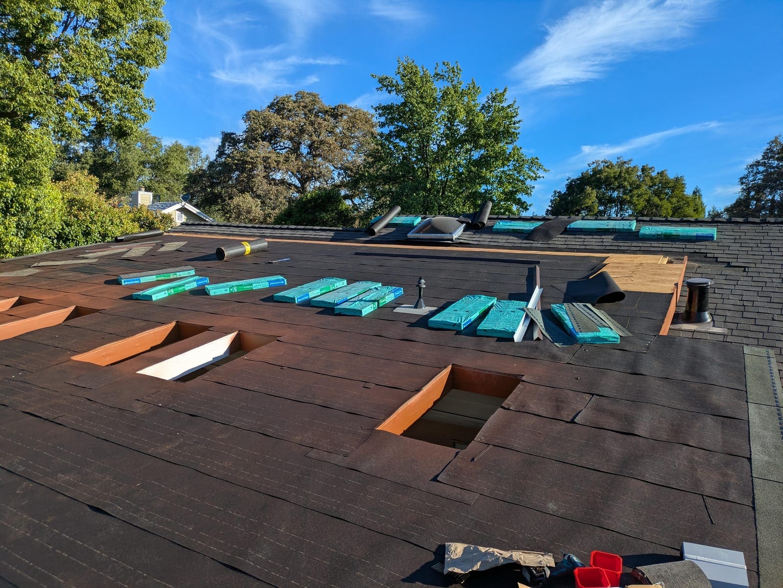 Underlayment complete with shingle bundles distributed across the roof