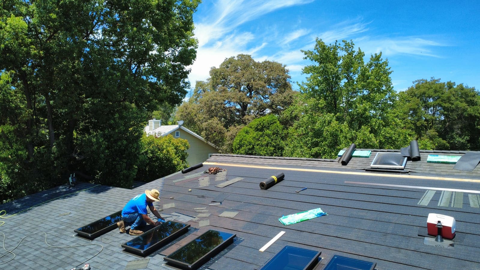 KTN Roofing crew member finishing skylight installation on a completed roof replacement